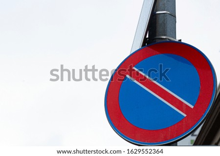No parking road sign against background. Hanging on the pole and close-up.