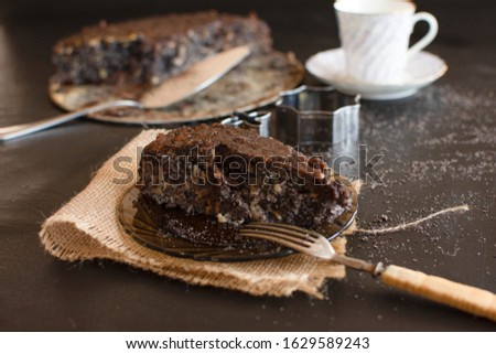 Poppy seed cake with nuts and raisins topped with dark chocolate.