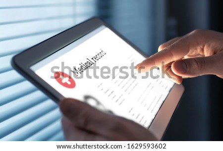 Medical record in electronic form. Digital EMR with patient health care information. Doctor using tablet in hospital or clinic. Personal data in mobile device. Online database for healthcare history. Royalty-Free Stock Photo #1629593602