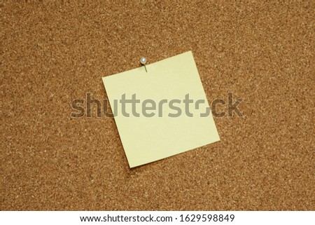 yellow blank note paper on bulletin board  