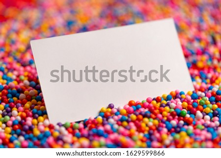 White Blank Business Card on Sprinkles For Cake Topping. Sugar Sprinkle Dot, Decoration for Cake and Bakery.