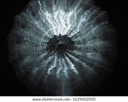 Blurry abstract silver star exploding in the darkness. Silver abstract background