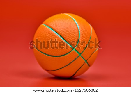 Basketball ball, red background. Spherical ball used in basketball games