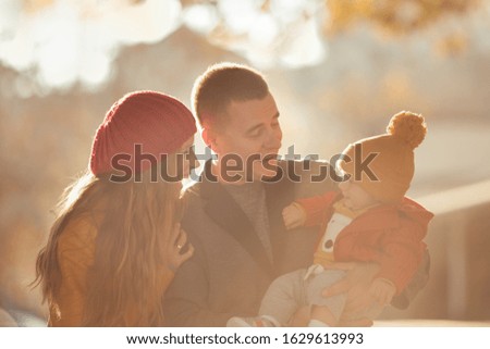 Beautiful happy family on a walk in the autumn park, outdoor