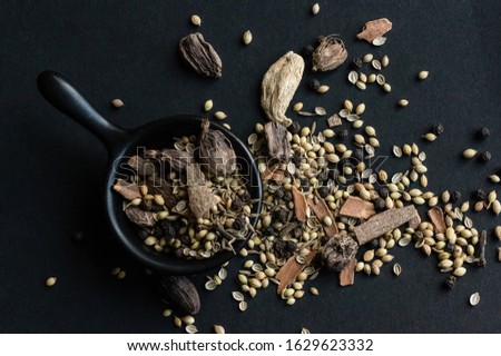 Mix spices spilled onto a dark background