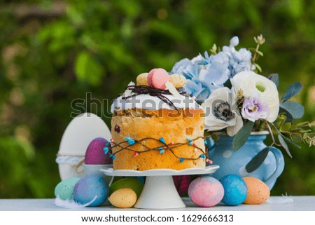 Easter sweet bread, flowers and colorful painted eggs