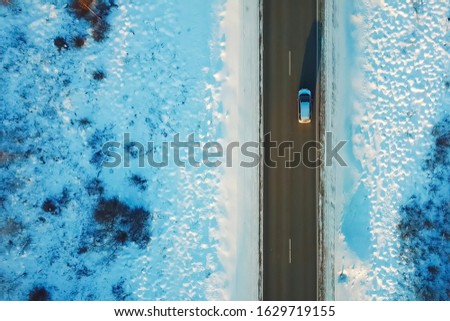 Car rides on a bridge over a ravine, view from above.