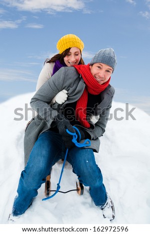 family sliding winter couple enjoying season