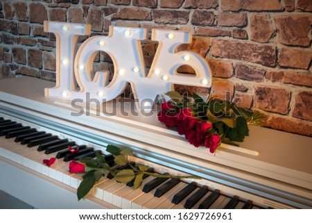 Love sign with flowers on a piano