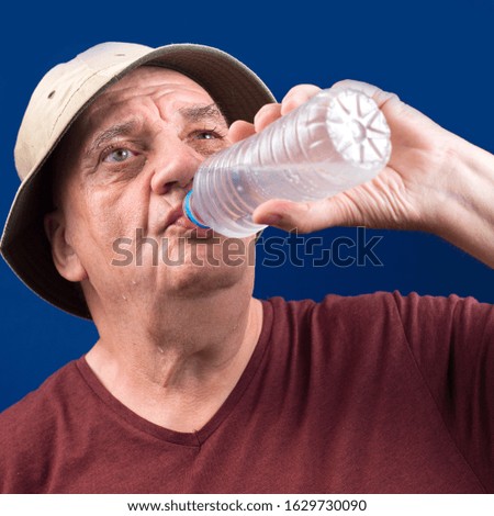 Old man drink water on the bottle