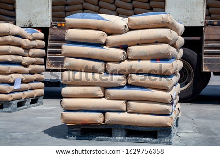 Cement bags are placed on pallets and stored in warehouses, Cement bags for construction, Cement industry  business. Royalty-Free Stock Photo #1629756358