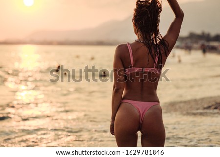 Young woman in bikini enjoying a summer day at the beach