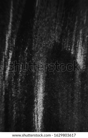 Black abstract minimalistic background. Smears of artistic ink on paper.