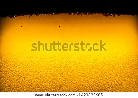 Close up of the beer,Close up in foam and bubbles of beer on black background,Water drops background