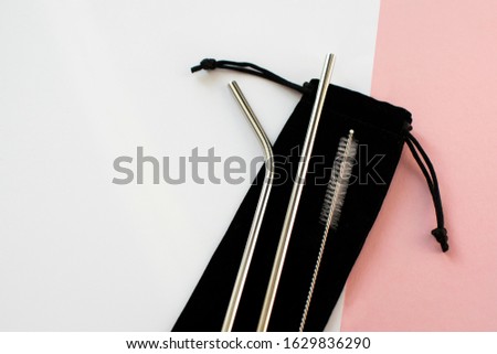 Reusable Metal Straws with Portable Case - Stainless Steel, Eco-Friendly Drinking Straw Set with  Cleaning Brushes & Travel Bag. Anti-Scratch Stainless Steel Straw Set of 2. Pink and white background. Royalty-Free Stock Photo #1629836290