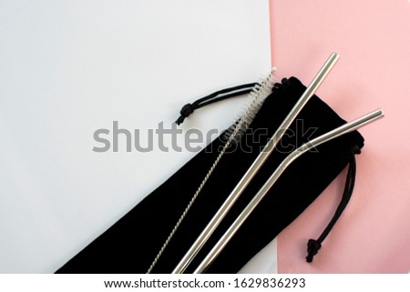 Reusable Metal Straws with Portable Case - Stainless Steel, Eco-Friendly Drinking Straw Set with  Cleaning Brushes & Travel Bag. Anti-Scratch Stainless Steel Straw Set of 2. Pink and white background. Royalty-Free Stock Photo #1629836293