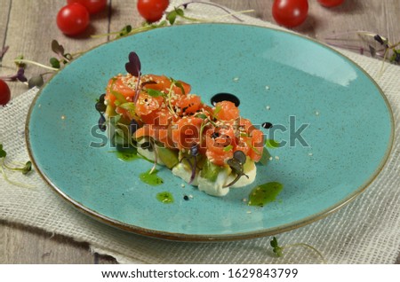 salmon and cheese appetizer on rustic background