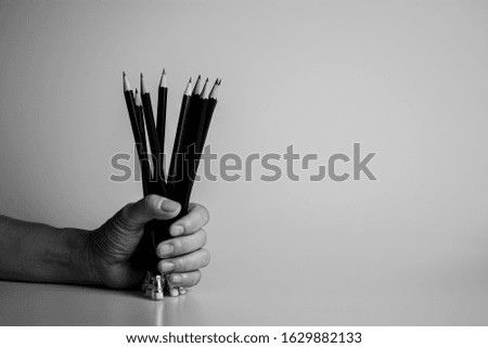Hand holding a pencil on the desk. - ideas and writer concept.