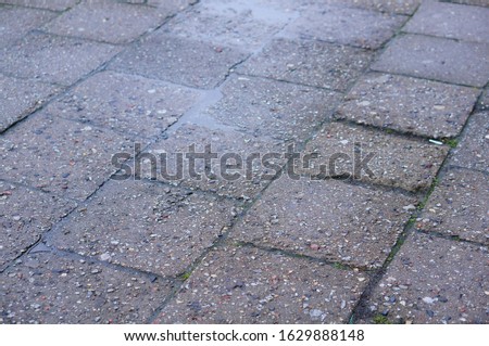 A high angle shot of the cobblestone ground of the street