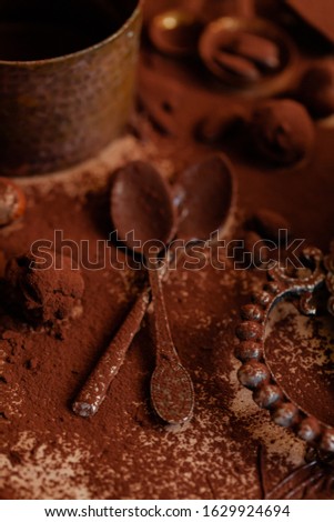 Delicious homemade chocolate preparation process. All kitchen tableware covered with cocoa powder. Intense brown color, aromatherapy. Dark and moody, macro, flat lay, top view
