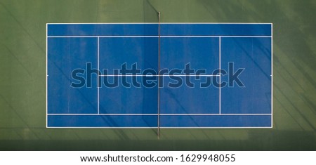 Aerial view of blue tennis court Royalty-Free Stock Photo #1629948055