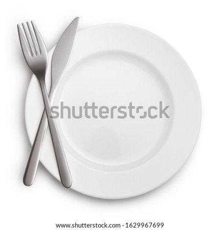 Fork and knife crossed on white plate, isolated on white background