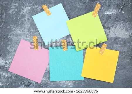 Paper sticky notes on grey background