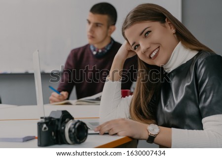 Beauty smiling woman in modern office working on project