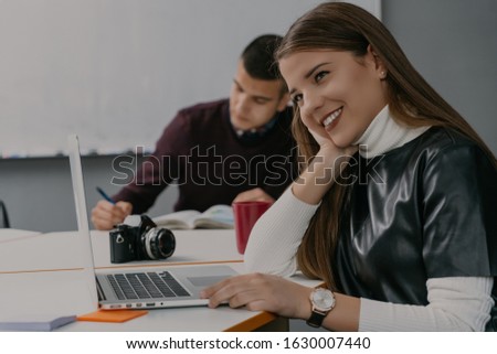 Beauty smiling woman in modern office working on project