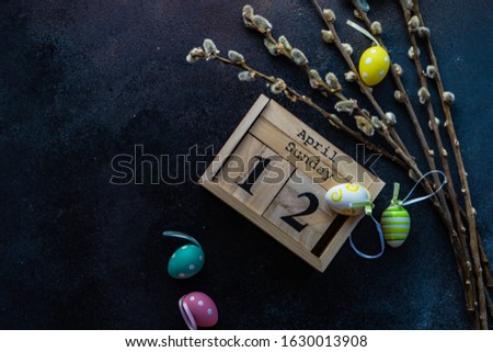 Easter card concept with colored eggs on stone background with copy space