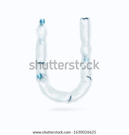 Letter U Made from Empty Plastic Water Bottles Isolated on White Background