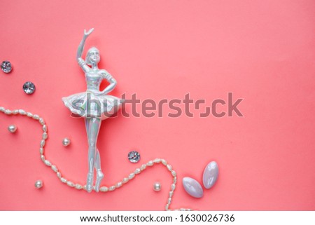 figurine of a ballerina girl on a pink background