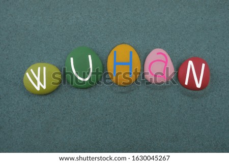 Wuhan, capital city of Hubei province, People's Republic of China, souvenir with multi colored stone letters over green sand