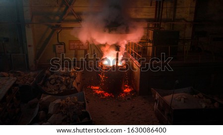 There is a melting of metal. Molten steel boils in the tank. Smoke rises from it.