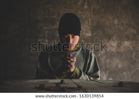 Portrait of a man praying with his eyes closed, spirituality and religion,man praying to god. Christianity concept. Royalty-Free Stock Photo #1630139854