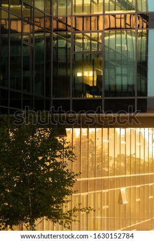 Reflection of sunset light in a window of a modern building.