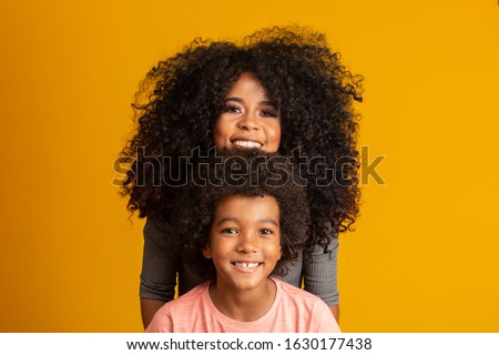 Mother and son with black power style hair. Royalty-Free Stock Photo #1630177438
