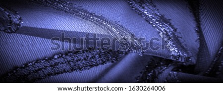texture  background image, the fabric is transparent deep blue with brightly congenital stripes, the material allowing the light to pass through it so that the objects behind are clearly visible.