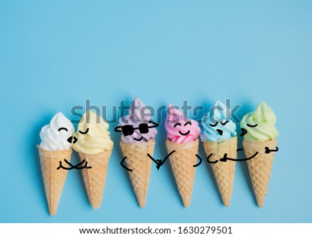 Emotion cartooning of colorful sweet ice cream cone isolated on blue pastel background ,holiday and relax concept
