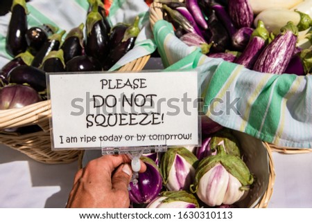 Funny sign asking not to squeeze the eggplants at a veggie shop at the local farmer's market. Real, genuine food from the countryside.