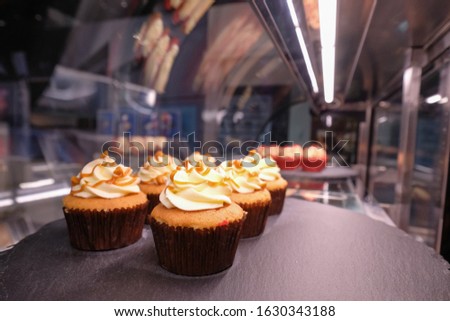 Delicious little cake in refrigitator on shelf.Fresh sweet pastry food for coffee break.Little cup cakes for dessert.Buy frozen bakery products