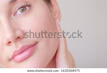 
face skin of a beautiful girl with pores closeup Royalty-Free Stock Photo #1630368475