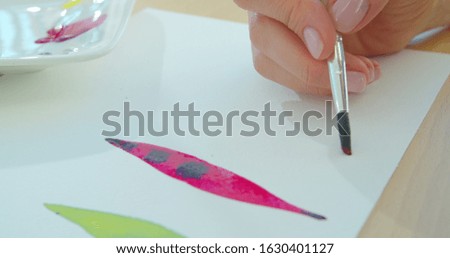 Woman artist painting watercolor paints.
