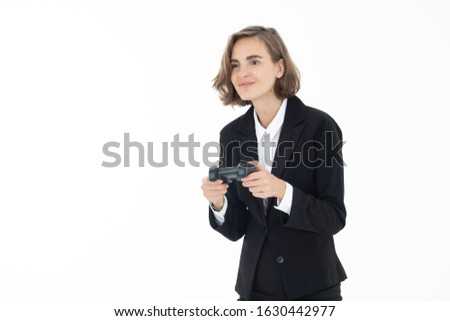 Young business woman is playing a video game on white isolated background.