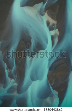 Bird's eye view from above on a green and blue glacier river stream in South Iceland. Beautiful patterns, textures and structures. Melting glacier, Global warming and climate change concept