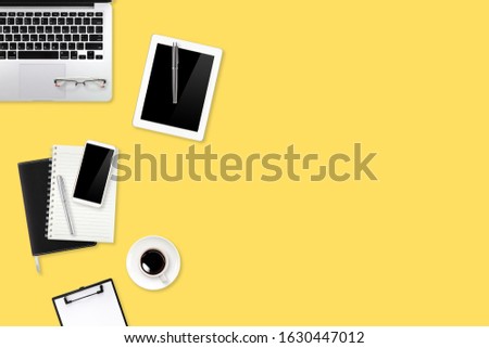 flat lay or top view workspace office yellow desk with laptop computer, coffee cup and smartphone using for business background