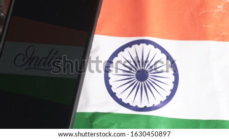 Mobile phone on the Indian flag, Concept for Indian Independence day and Republic day. A place for text on screen.