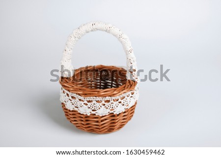 Braided basket with lace isolated on a white background