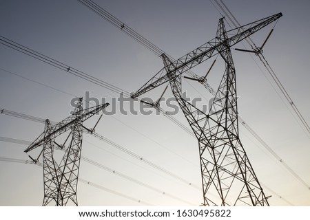 two Australian high voltage power lines at dusk Royalty-Free Stock Photo #1630495822
