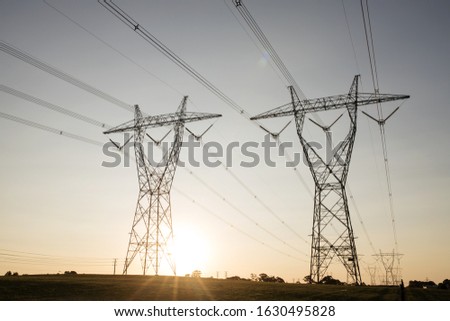 landscape of Australian high voltage power lines with sunset in background. Royalty-Free Stock Photo #1630495828